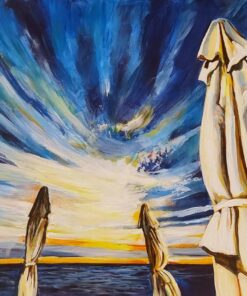 l tramonto si colora di contrasti e bagliori dinamici. In primo piano tre ombrelloni da spiaggia richiusi a fine giornata Marco Ronga